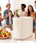 No Fuss Countertop Ice Maker Pumping Out 18 Lbs Of Crisp Bullet Ice Every 6 Minutes with drinks and fruit during a party.