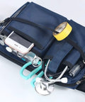 Heavy Duty Utility Waist Pack With Modular Tool Dividers And Waterproof Zippers For Job Site Hustlers Seeking Kick Ass Storage For Drill Bits Pliers And Pro Gear Built Tough As Nails Every Single Shift, featuring tools and phone.
