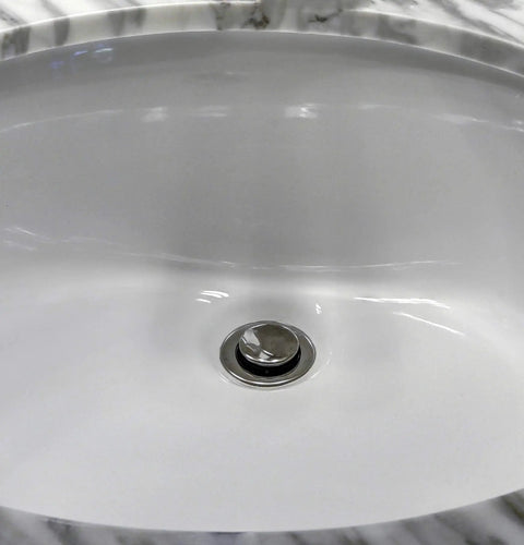 Two Hole Chrome Pop Up Stopper For Universal Sink Drain With O Ring Seal And Easy Install No Hassle Fits Most Pop Up Drain Units Cap Diameter One And Three Eighths Inch in white oval bathroom sink.
