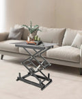 Heavy Duty 24V Electric Scissor Lift Table With 180 Lbs Capacity And Remote Control Featuring Durable Iron Frame For Rugged Jobsite Lifting Tasks in living room setting with decorative items.