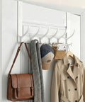 Over-the-door hook rack, white, 12 hooks, mounted on door; coat, scarf, hat, and bag hanging.