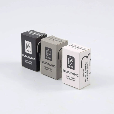 Two Step Long Point Pencil Sharpener With German Steel Blades In White Matte Finish boxes displayed on a surface