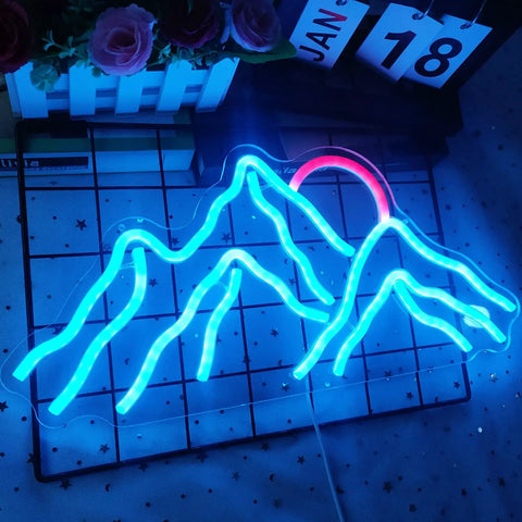 Blue and pink mountain neon sign on a grid background with pink flowers and calendar blocks.