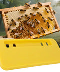 Beekeeping Honey Uncapping Tank Holder For Easy Harvesting And Frame Scraper with bees on honey frame and yellow holder