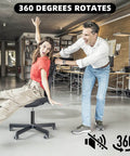 Two people enjoying the 360-degree rotation feature of an office chair in a modern workspace.