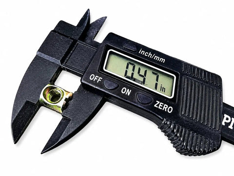 Digital caliper measuring a barrel nut from Beefed Up Barrel Nut And Bolt Fastener Set For Furniture, Heavy Duty Cross Dowel Connectors Kit
