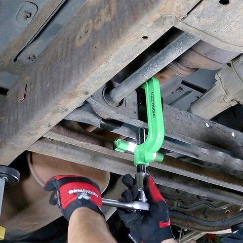 Beefy Heavy Duty Torsion Bar Removal Tool With Extended C Frame And Ford Dodge Adapter in use under vehicle suspension