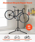 Heavy Duty Bike Repair Stand With 85 Lb Capacity, Adjustable 40.7 To 64.1 Inch Height, holding a road bike in home shop.