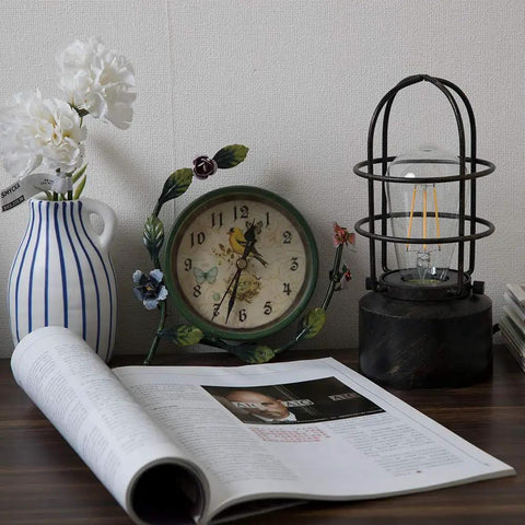 Industrial Table Lamp With Touch Control And 3 Way Dimming on a desk with a clock, vase, and open book