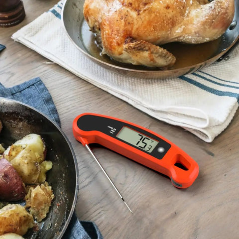 Instant Read Meat Thermometer With Ultra Fast Two Second Read Time, Auto Rotating Backlit Display next to roasted chicken and potatoes