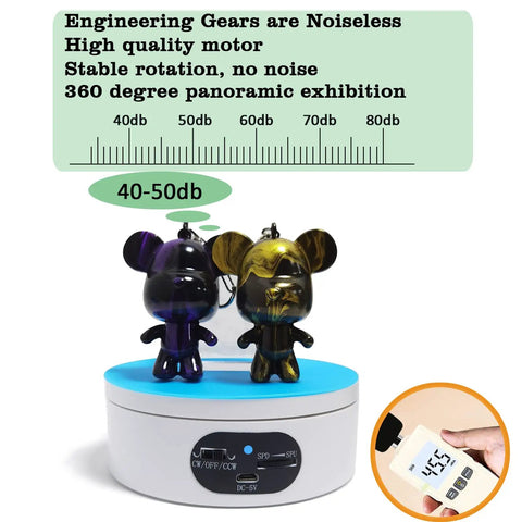 360 Degree Motorized Rotating Display Stand White Electric Spinner Turntable For Tumblers Jewelry Photography Products Adjustable Speed Turner Base Showpiece Prop showcasing two decorative figurines on a blue surface.