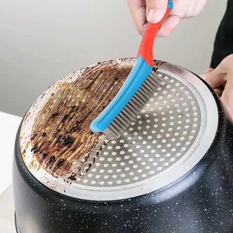 Heavy Duty Stainless Steel Wire Brush for cleaning metal rust removal and paint scrubbing with rubber covered handle in use on grimy pan