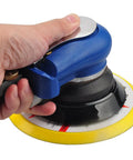 Hand using 6 Inch Random Orbit Air Sander With Hook And Loop Backing Built In Variable Speed Regulator Pneumatic Sander.