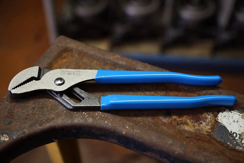 Two Piece Tongue And Groove Pliers Set 9.5 Inch And 12 Inch Slip Joint High Carbon Steel with blue rubber grips on rusty surface