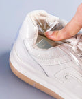 Clear Thermal Shrink Wrap Bags 12X17 Inches 100 Pack used on a white sneaker to protect it from dust and damage.