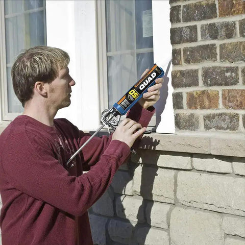 Person applying Beige Window Door And Siding Sealant 10 Oz Tubes Advanced Formula Weatherproof Exterior Caulk on brick wall