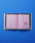 Open astrology guide on a blue background with pages detailing Mercury Retrograde horoscope aspects.