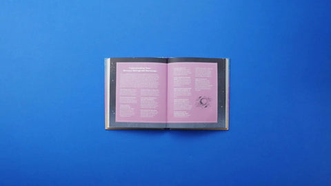 Open astrology guide on a blue background with pages detailing Mercury Retrograde horoscope aspects.