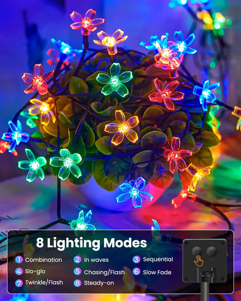 60 LED Cherry Blossom Solar String Lights Outdoor Waterproof Fairy Lights on a plant with visible lighting modes