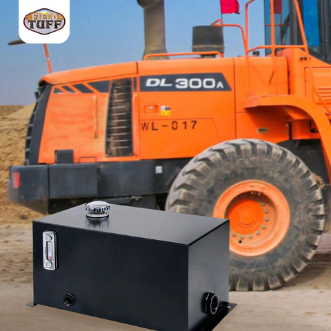 10 Gallon Welded Steel Hydraulic Reservoir Tank 14 Gauge Metal Construction Black Finish With 2 Inch Suction Port And 0.75 Inch Return Port For Reliable Fluid Storage And Smooth Pump Operation shown in front of an orange construction vehicle.