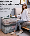 Heavy Duty Collapsible Storage Bins With Lids Super Sturdy Plastic Folding Crate organized with clothing, placed next to a sofa.