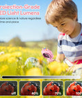 Kids Digital Microscope With 2.4 Inch Hd Screen, 600X To 4800X Magnification, Handy Handheld Miniscope For Super Fun Photos And Videos, Portable Education Toy For Ages 3 4 5 6 7 8 9 10, Boys And Girls. Pink handheld kids microscope used outdoors in a flower field