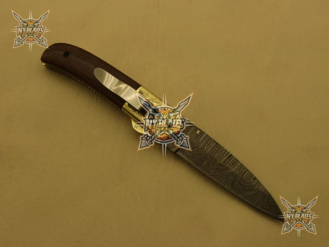 Damascus Steel Folding Knife With Rosewood Handle And Floral Brass Bolster, 4.5 Inch Overall Drop Point Blade, displayed open on a light surface