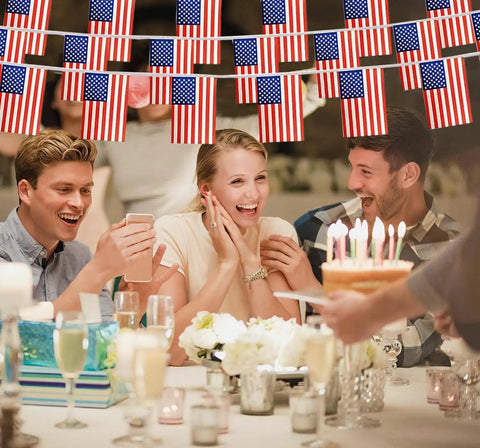 People celebrating under Patriotic String Flags Banner Set For Memorial Day And Fourth Of July, 65 Feet US Flag Garlands
