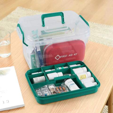1 Pack Plastic Medicine Storage Kit All In One With Detachable Green Tray And Eight Grid Compartments Clear First Aid Storage Box With Sturdy Handles Portable Household Organizer For Meds And Small Supplies, open view showing organized supplies with green tray on a wooden table.