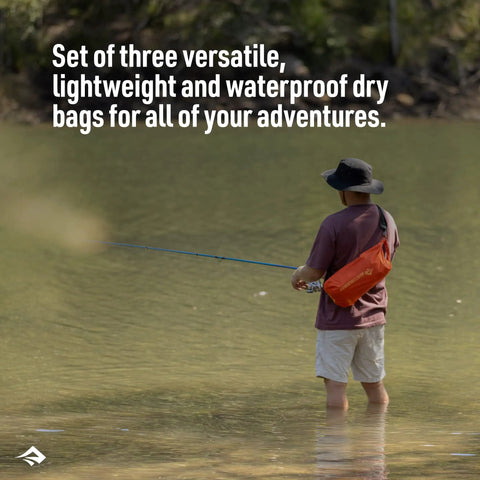 Person fishing with an orange dry bag from the Lightweight Go-To Dry Bag Set Three-Piece 3L 5L 8L For Backpacking Hiking Camping Kayaking And Travel, Water-Resistant PU-Coated Nylon With Roll-Top Closure, Keeps Gear Dry And Organized