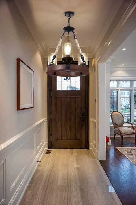 Farmhouse Wagon Wheel Ceiling Chandelier With Wood Frame And Seeded Glass Shades in a hallway entrance setting