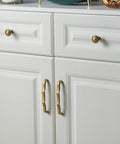 Solid Brass Cabinet Pulls 5 Pack, 5 Inch Hole Center Drawer Handles installed on white cabinets