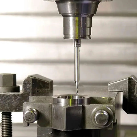 Carbide end mill (1/8 in shank) upcut router bit, single-flute, mounted in milling vise