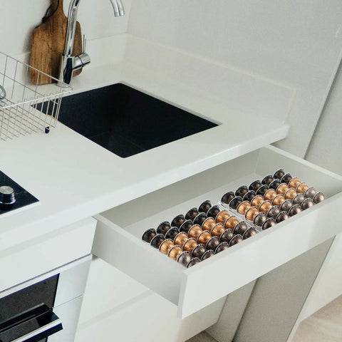 Coffee Pod Drawer Organizer For Nespresso VertuoLine Holds 30 Pods, clear acrylic insert in a kitchen drawer next to a sink.