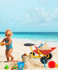 Child playing with Kids Ride On Sand Dumper Outdoor Sandbox Toy With Ergonomic Handle And Four Wheels Built Tough Metal Wheelbarrow