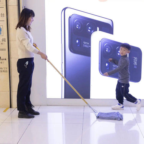 Heavy Duty Commercial Mop Set With Fifty Eight Inch Handle And Three Machine Washable Cotton Loop Heads being used on a clean floor.