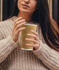 Woman holding 90 Pack 16 Oz Disposable Coffee Cups No Lids Insulated Ripple Wall Champagne Corrugated Paper Cups Go To Coffee Hot Chocolate Tea On The Go Travel Office Home For Catering And Office Use