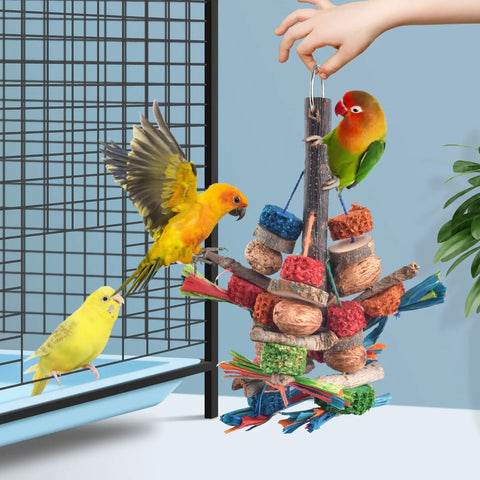 Hella Tough Parrot Chew Toys Crafted From Natural Wood Hemp Rope Corn Cob And Sweet Treat Nuts For Big Time Foraging Fun In Conure Cockatoo Parakeet Budgie Cage with colorful wooden pieces and birds.