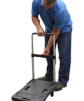 Man adjusting handle of Plastic Fold Flat Cart Workhorse With Three Height Adjustable Handle Cushioned Grip Rubber Deck Non Slip Surface 300 Lb Capacity Black
