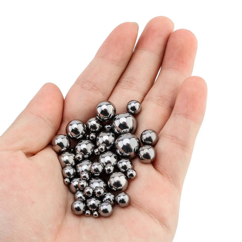 Hand holding 500 piece bicycle bearing balls kit with eleven sizes, precision steel balls for bearings, perfect for bike hubs and DIY fixes.