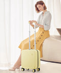 Underseat Carry-On Luggage 16 Inch Hardside PC Suitcase With Spinner Wheels And TSA Lock For Easy Grab-And-Go Travel In Bright Lark Yellow next to seated woman