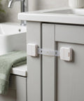 Adhesive Baby Locks With Key for Cabinets showing installation on a bathroom cabinet
