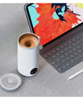 Grab And Go Heated Self Stirring Mug Electric Magnetic Mixing Travel Cup Rechargeable Stainless Steel Coffee And Tea Warmer on desk.