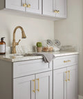 Davenport Champagne Bronze Cabinet Pull Six and a Half Inch Overall Length Five and One Sixteenth Inch Center to Center on gray cabinets