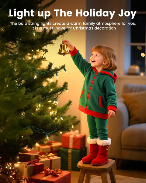 Child in festive outfit decorating a Christmas tree with Clear Christmas String Lights 100 Count On Green Wire 20 Feet Incandescent Mini Bulbs