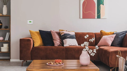 Living room with a 7 Day Programmable Thermostat With Backlit Digital Display And Precise Temperature Control To Within 1 Degree Fahrenheit on the wall.