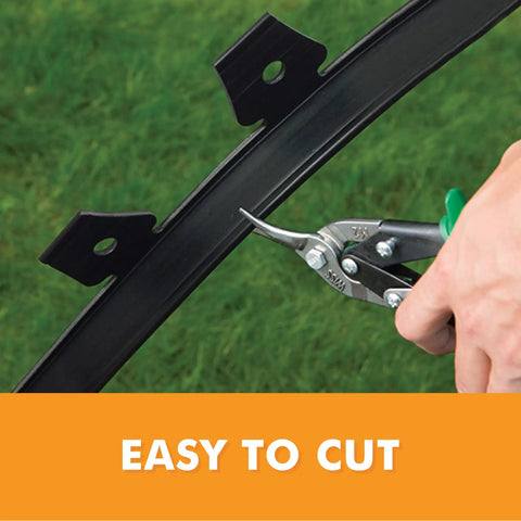 Cutting flexible recycled plastic of Tall Wall No Dig Landscape Edging Kit for DIY Gardens, includes three 30 ft coils and 24 spikes.