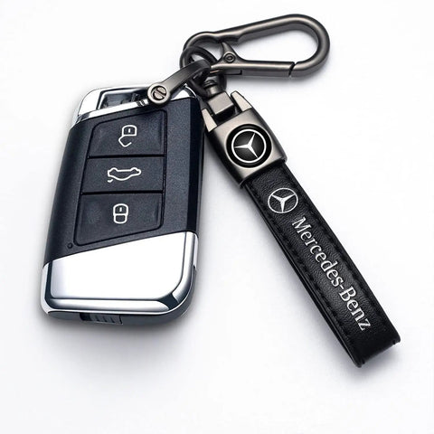 Mercedes Benz Tire Valve Caps And Metal Keychain Set with black leather strap and carabiner clip on white background.