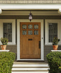 Wikshire 8 Inch Wide 1 Light Outdoor Pendant in coffee bronze with clear crackle glass shown on a porch entryway.