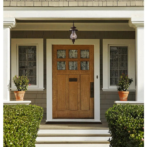 Wikshire 8 Inch Wide 1 Light Outdoor Pendant in coffee bronze with clear crackle glass shown on a porch entryway.